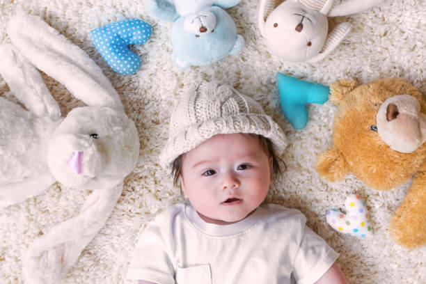 istock Baby boy with his stuffed animals on a carpet 1093363256
