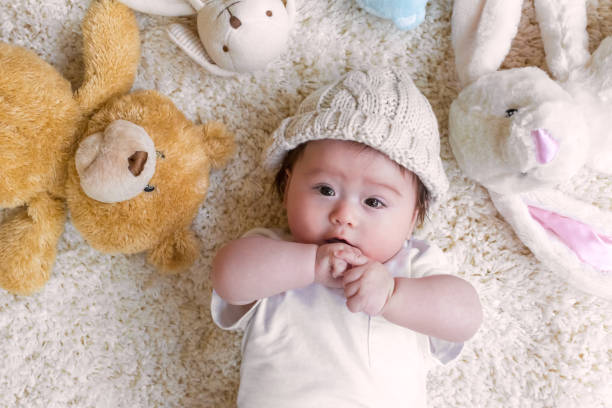 istock Baby boy with his stuffed animals on a carpet 1093363278