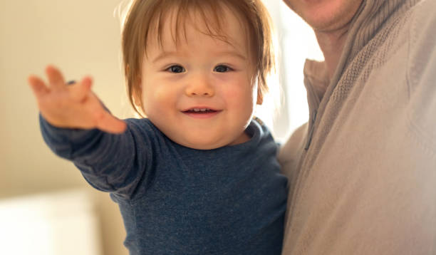 istock Happy toddler boy being held by his parents 1093363360