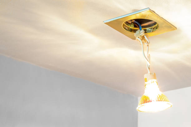 istock Repair electrician worker concept. lightbulb hanging out from ceiling. Background with copy space. 1093368194