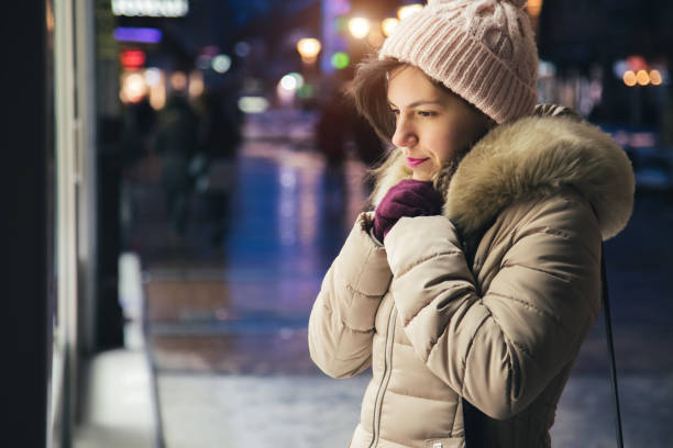 istock Woman window shopping at night 1093370294