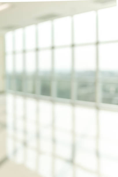 istock Blur background interior view looking out toward to empty office lobby and entrance doors and glass curtain wall 1093375694