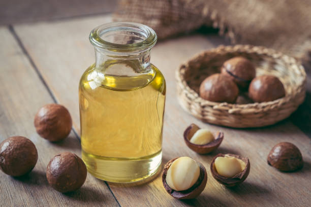 istock Macadamia oil in bottle and macadamia nuts on wooden table 1093376246