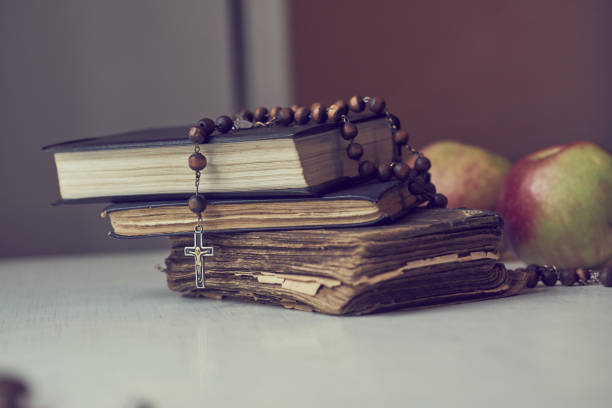 istock The rosary beads on Catholic Church liturgy books and apples behind them. 1093376852