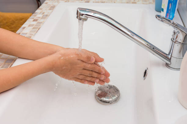 istock Baby washes his hands in the bathroom 1093377176