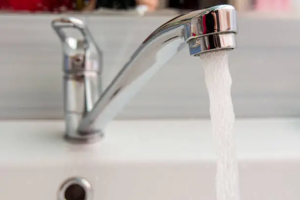 Water pours more pressure from the mixer in the bathroom