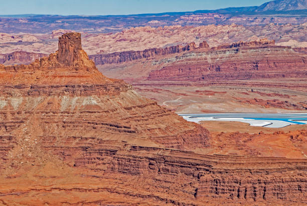 istock Salt Flats under a dominating tower spire in Monument Valley National Park. 1093390902