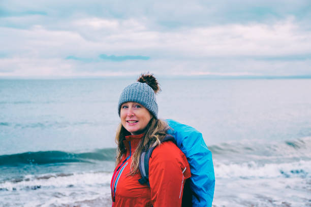 istock Woman walking by the sea 1093391270