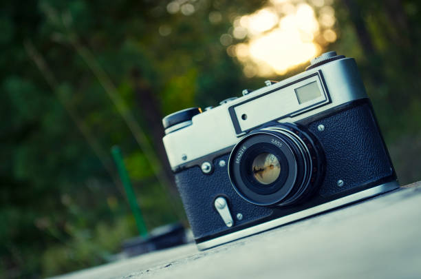 istock old camera in nature , green and yellow background 1093396972
