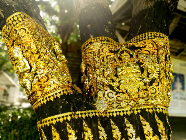 istock Brass plate carved in Thai style on a tree. 1093418564
