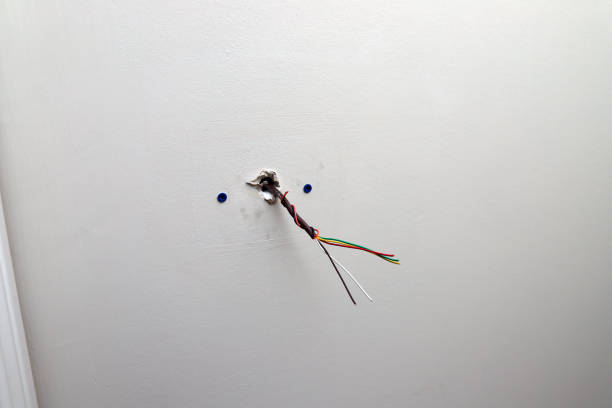 istock Control wire for thermostat coming out of wall during maintenance and installing 1093420328