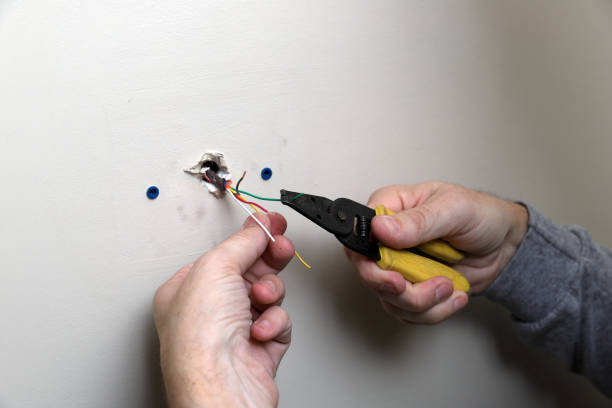 istock maintenance tech installs wiring for thermostat 1093420386