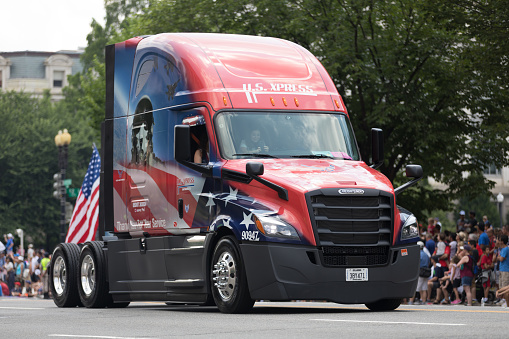 Washington, D.C., USA - July 4, 2018, The National Independence Day Parade, Truck painted in the colors of the american flag and carrying a national flag, going down constitution avenue