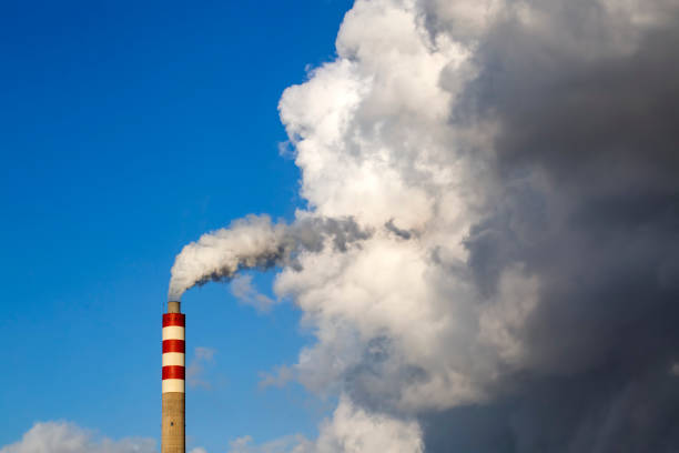 istock Factory chimney smoke with blue sky and clouds 1093431702