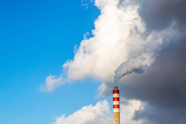 istock Factory chimney smoke with blue sky and clouds 1093431726