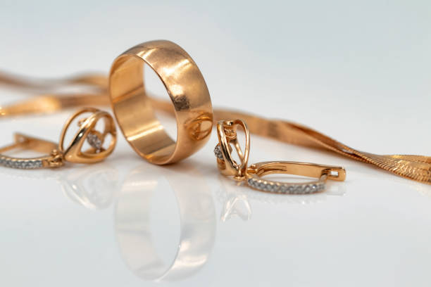 istock earrings with dancing diamonds, gold ring and gold chain 1093453432
