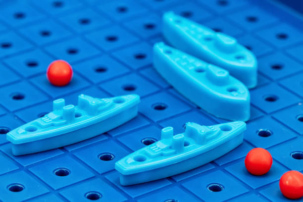 istock Toy war ships and submarine are placed on the blue  playing Board 1093455182