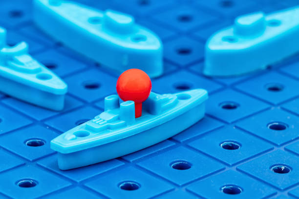 Toy war ships and submarine are placed on the blue  playing Board