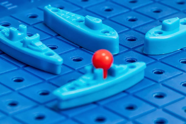 istock Toy war ships and submarine are placed on the blue  playing Board 1093455318