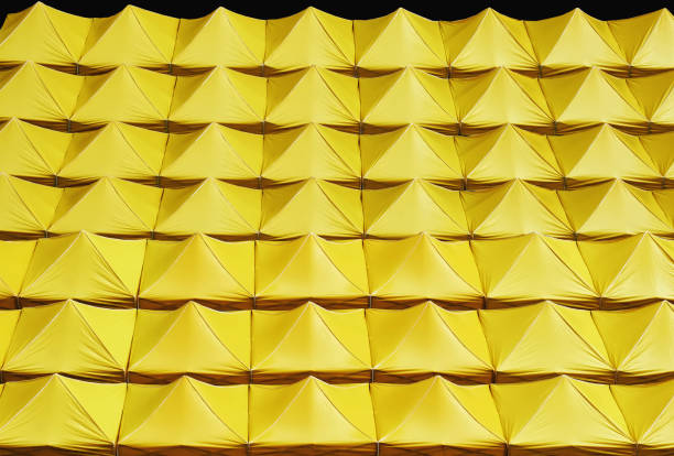 istock Full Frame Background of Yellow Canvas Roofs Isolated on Black 1093462794