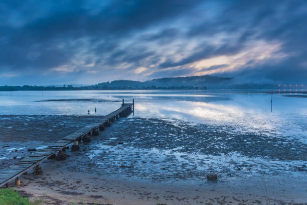 istock Misty Blue Dawn Bay Waterscape With Wharf 1093465038