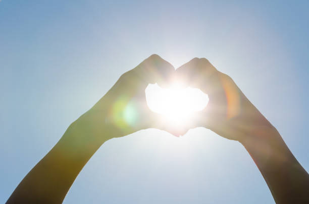 istock Sun in woman's heart shaped hands 1093468362