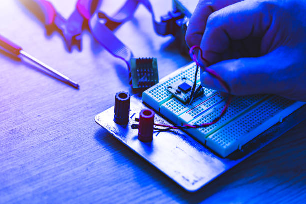 istock Engineering student holding wire in hand and inserting to electronic bread board, Concept of technical eduction. 1093474586