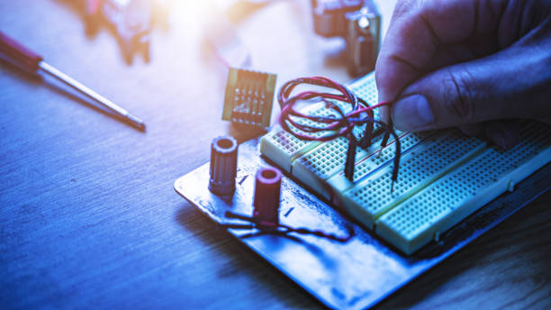 istock Engineering student holding wire in hand and inserting to electronic bread board, Concept of technical eduction. 1093474590