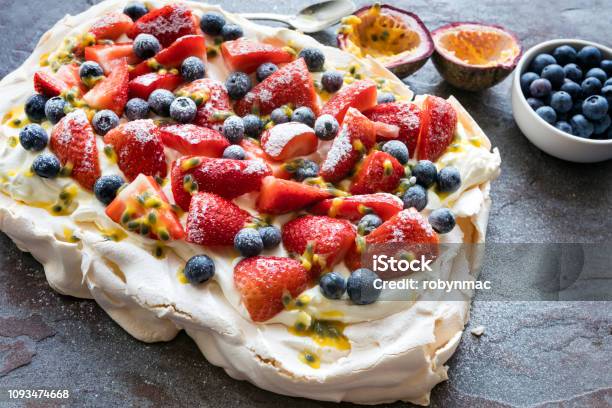Pavlova Meringue Cake With Berries And Passionfruit Stock Photo - Download Image Now