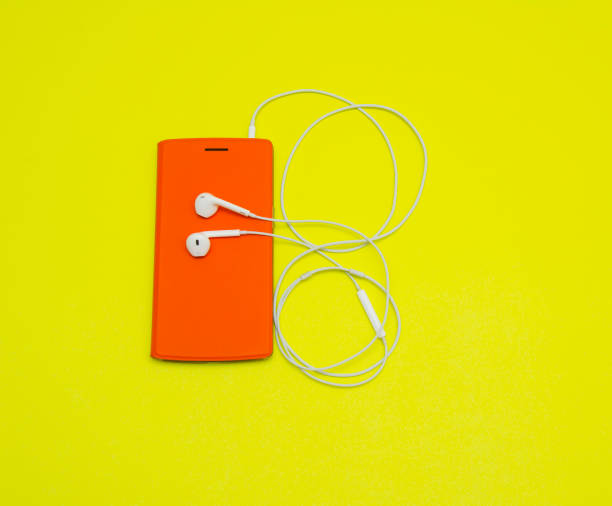 istock Smartphone with Earphones on Yellow Background 1093476352
