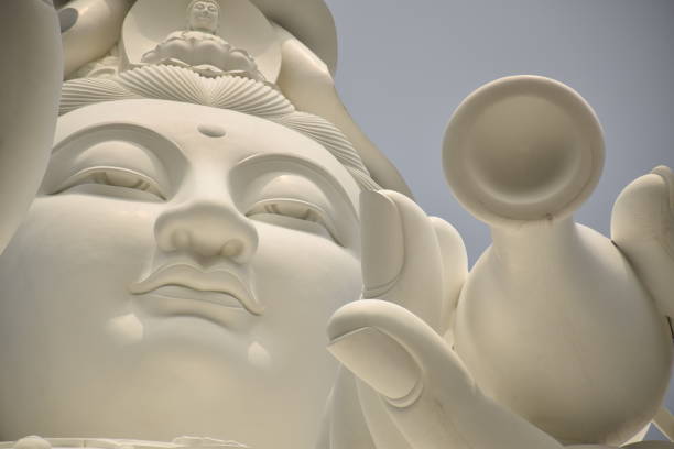 Close up of the bronze Guanyin statue inside Tsz Shan buddhist monastery in Tai Po, Hong Kong - China Guanyin or Guan Yin is the most commonly used Chinese translation of the bodhisattva known as 'Avalokitesvara' kannon bosatsu stock pictures, royalty-free photos & images