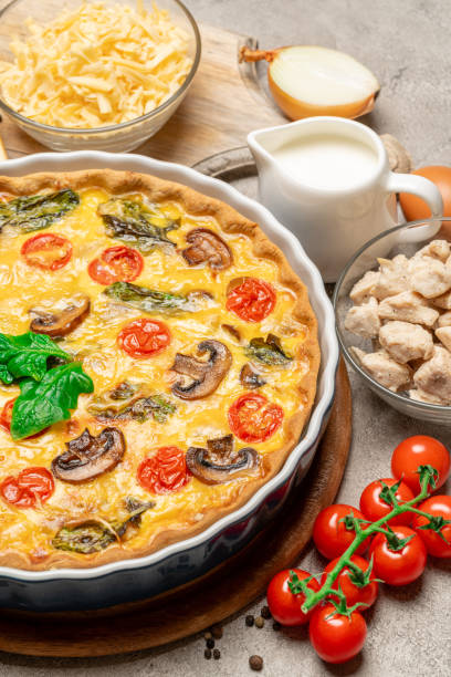 istock Baked homemade quiche pie in ceramic baking form, eggs and cream 1093487538