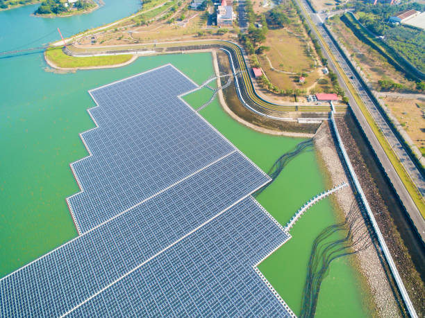 aerial view of Floating solar panels or solar cell Platform on the lake aerial view of Floating solar panels or solar cell Platform on the lake floating electric generator stock pictures, royalty-free photos & images