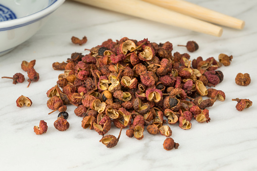 Heap of dried chinese Sichuan pepper close up