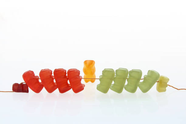 gummy bear story series - tug of war with referee (teamwork and competition concept) - tug o war imagens e fotografias de stock