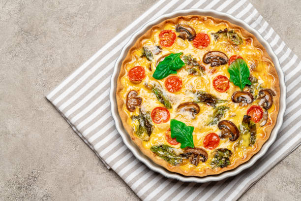 istock Baked homemade quiche pie in ceramic baking form 1093493436