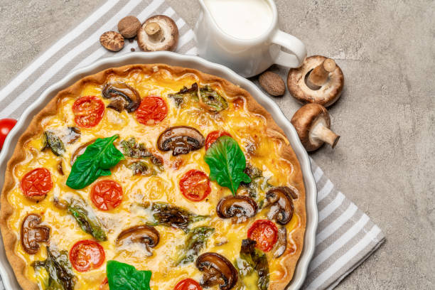 istock Baked homemade quiche pie in ceramic baking form 1093493486