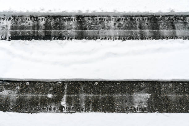 istock cleared path through deep snow on an asphalt road after a heavy snowfall 1093493582