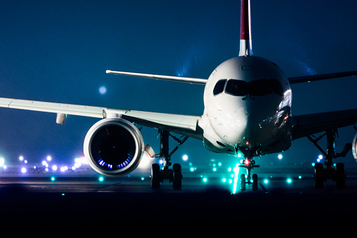 Commercial jet, front view, snow, night