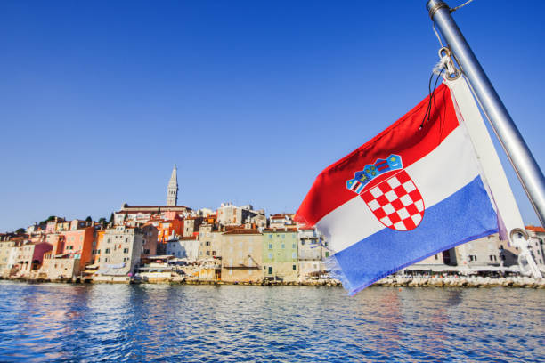 Croatian flag with Rovinj town, Croatia. Travel vacations concept Vacations in Croatia. View of Rovinj old town, Croatia croatian culture photos stock pictures, royalty-free photos & images