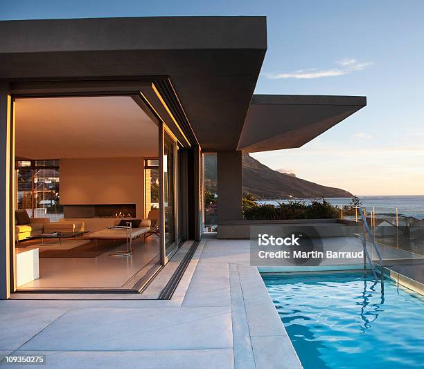 Modern Living Room And Patio Next To Swimming Pool Stock Photo - Download Image Now - Luxury, Domestic Life, House