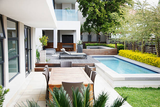 modern patio next to swimming pool - luxe stockfoto's en -beelden