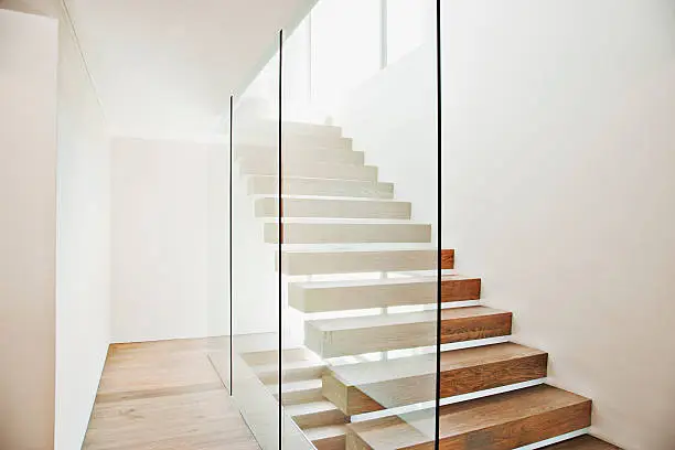 Photo of Floating staircase and glass walls in modern house