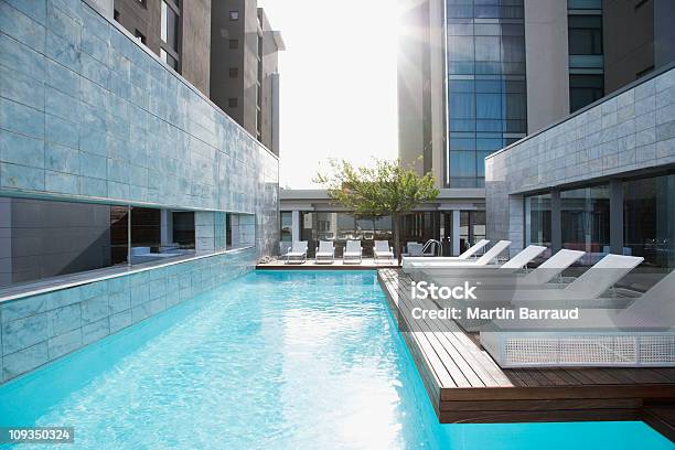 Modern Lounge Chairs Next To Swimming Pool Stock Photo - Download Image Now - Hotel, Swimming Pool, Luxury