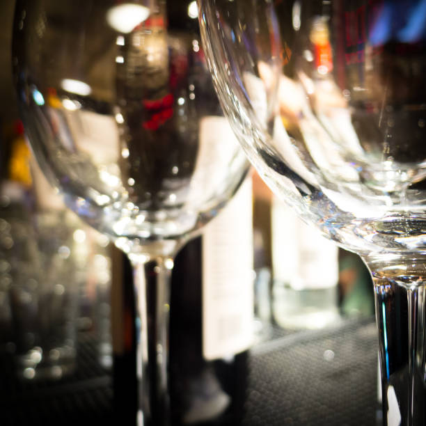 Empty wine glasses on a bar stand.