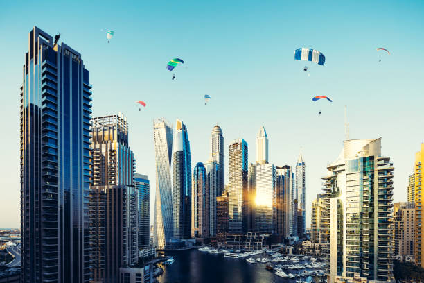 Dubai Marina Skyline and Fun Parachuting Activities at Dawn Activity, Flying, Dubai Marina, Jumeirah, Expo 2020 Dubai, Skydiving, Cityscape skydiving stock pictures, royalty-free photos & images