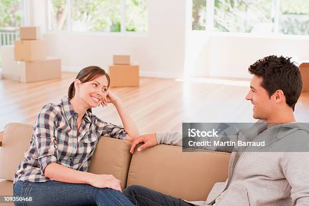 Foto de Casal Relaxando No Sofá Em Casa Nova e mais fotos de stock de 25-30 Anos - 25-30 Anos, 30 Anos, 30-34 Anos