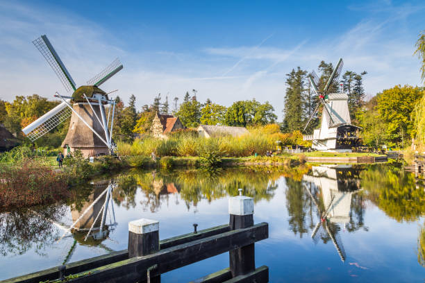 Historic Dutch scene with two windmills Arnhem, Netherlands - November, 04, 2018:: Historic Dutch scene with two old windmills in the open air museum in Arnhem in the Netherlands arnhem photos stock pictures, royalty-free photos & images