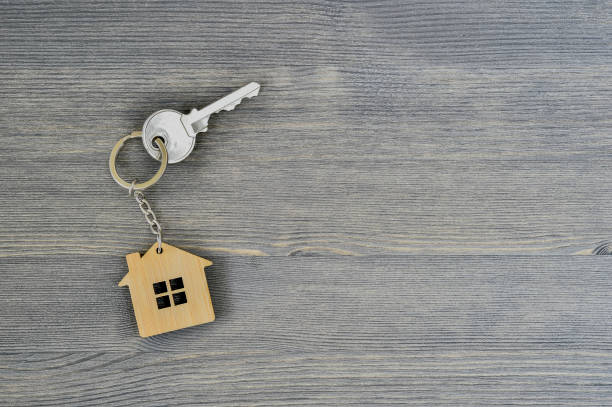istock Metal key lock home in bamboo keychain for wooden rustic gray background. Copy space 1093507790