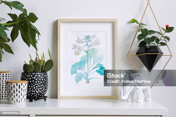 Home Interior Floral Poster Mock Up With Vertical Wooden Photo Frame A Lot Of Plants Cacti Hanging Plant In Geometric Pot On White Wall Background Concept Of White Shelf Stock Photo - Download Image Now